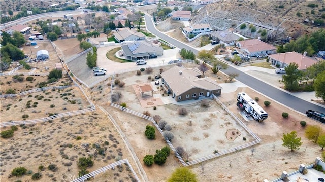 birds eye view of property featuring a residential view and a desert view