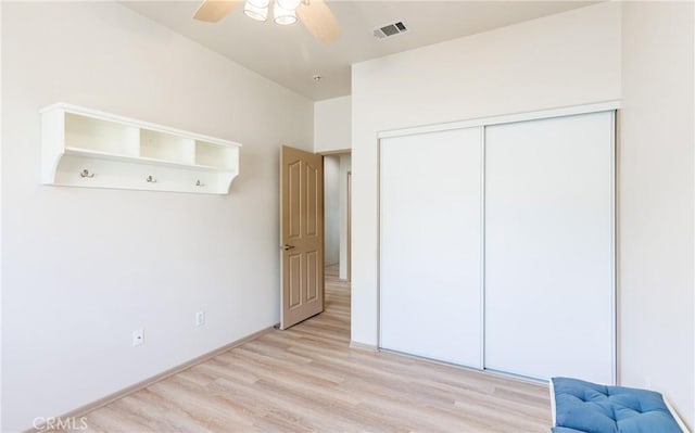 unfurnished bedroom with a ceiling fan, a closet, visible vents, and light wood-style floors