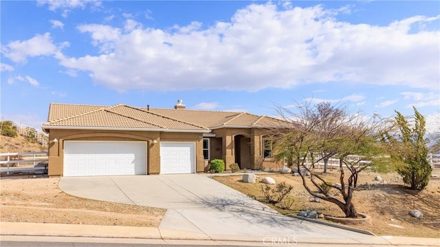 mediterranean / spanish home with a garage, concrete driveway, a tile roof, fence, and stucco siding