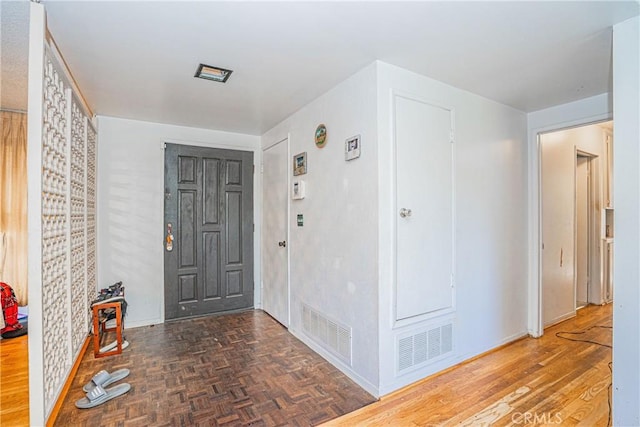 entrance foyer featuring parquet flooring and visible vents