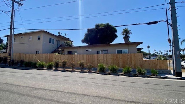 exterior space featuring fence and stucco siding