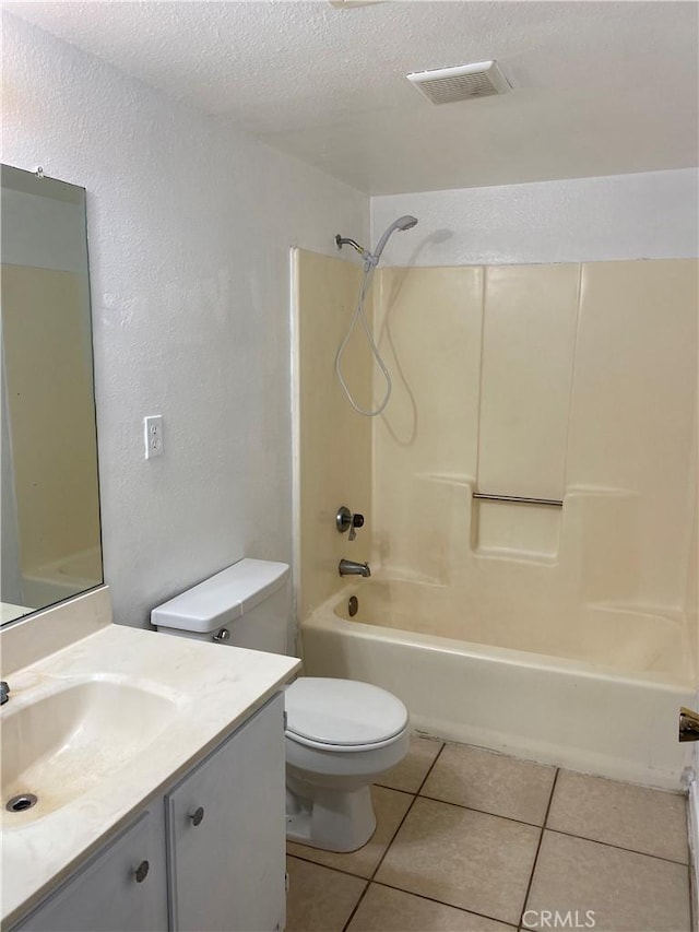 bathroom with vanity, a textured ceiling, toilet, and tile patterned floors