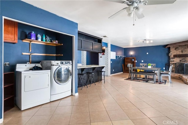 laundry room with washer and dryer, laundry area, light tile patterned floors, and ceiling fan