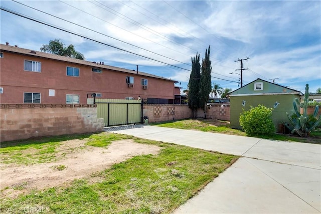 view of yard featuring a fenced front yard and a gate