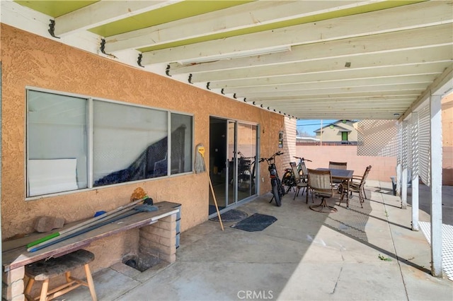 view of patio / terrace featuring outdoor dining area and fence