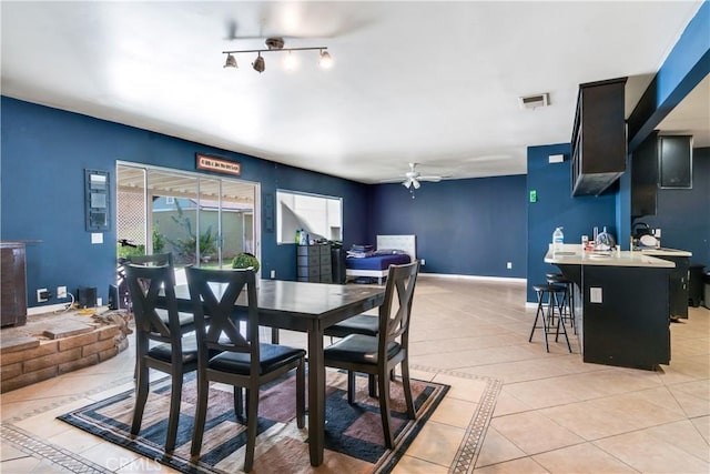 dining space featuring ceiling fan, visible vents, baseboards, and light tile patterned flooring