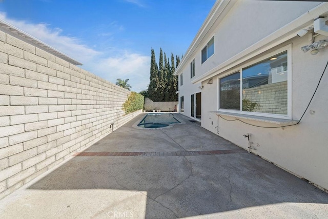 view of property exterior with a patio area, a fenced backyard, and stucco siding