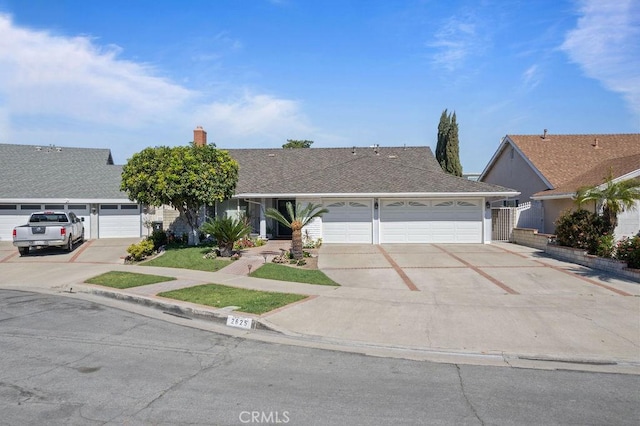 ranch-style house featuring a garage, roof with shingles, driveway, and a chimney