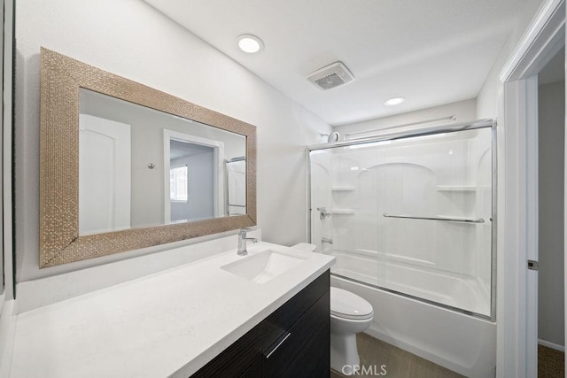 full bathroom featuring visible vents, bath / shower combo with glass door, toilet, vanity, and recessed lighting