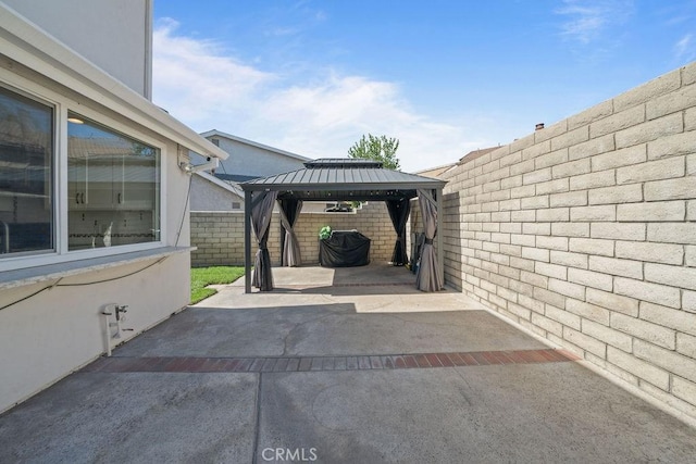 view of parking / parking lot with a gazebo and a fenced backyard