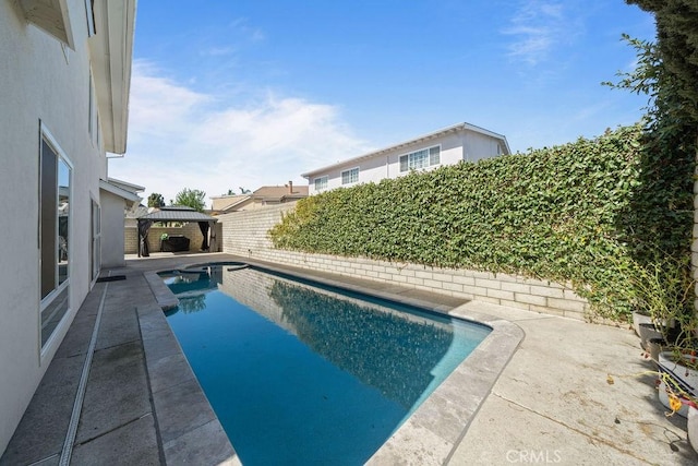 view of swimming pool with a gazebo, a patio area, a fenced backyard, and a fenced in pool