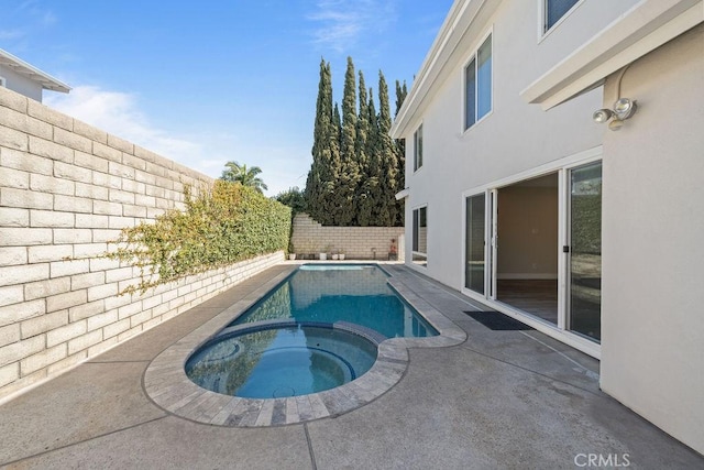 view of swimming pool with a patio, a fenced backyard, and a pool with connected hot tub