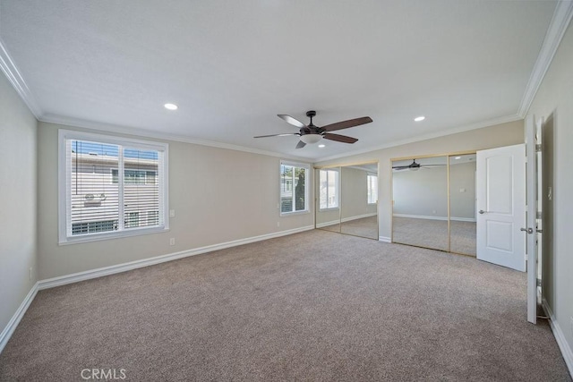 unfurnished bedroom featuring baseboards, two closets, and crown molding