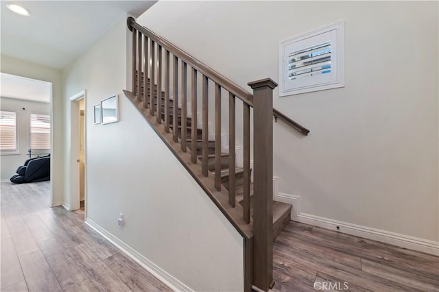 stairs featuring baseboards and wood finished floors