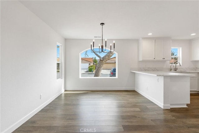 unfurnished dining area with visible vents, baseboards, dark wood-style flooring, and recessed lighting