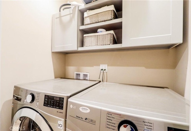 laundry room featuring cabinet space and washing machine and dryer