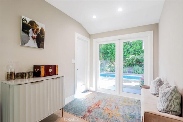 entryway with lofted ceiling, recessed lighting, and baseboards