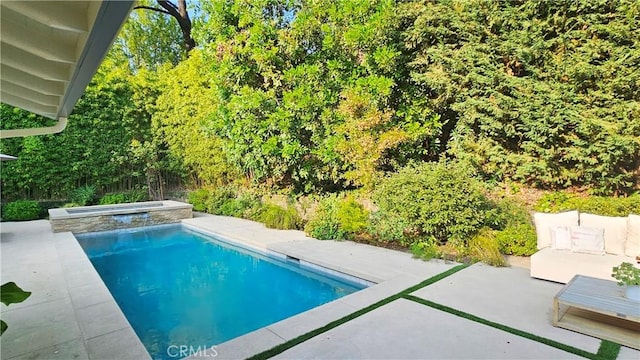 view of swimming pool featuring a pool with connected hot tub and a patio