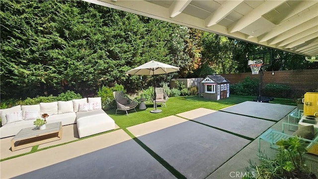 view of patio with an outdoor living space and a fenced backyard