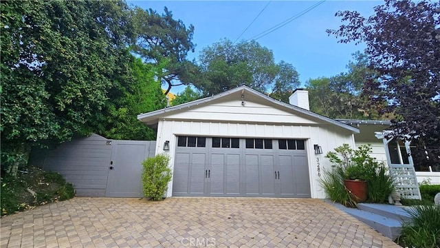 garage with driveway and a gate