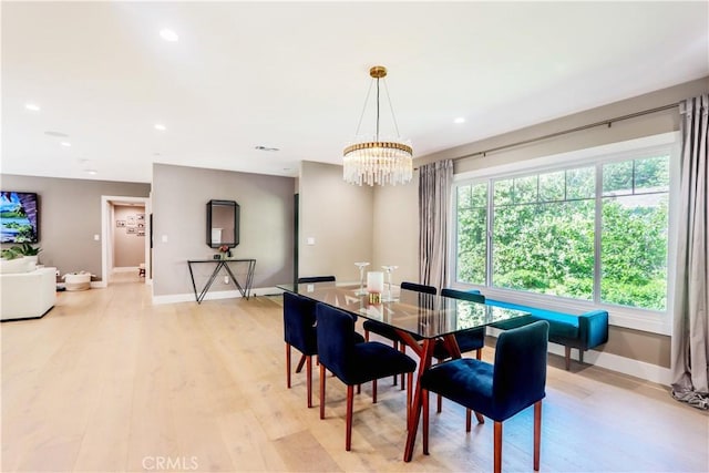 dining area with recessed lighting, light wood-type flooring, baseboards, and a chandelier