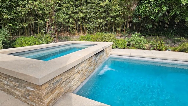 view of swimming pool featuring an in ground hot tub