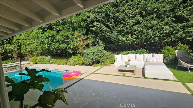 outdoor pool featuring a patio and an outdoor living space