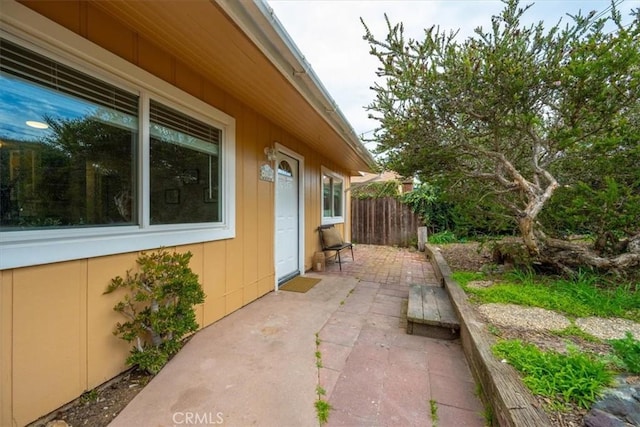 view of home's exterior featuring a patio area and fence