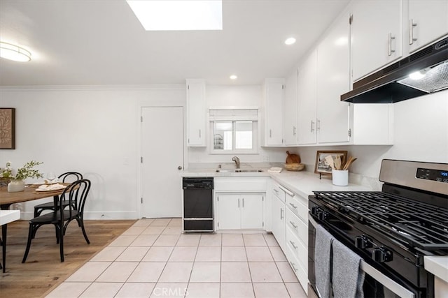 kitchen with black dishwasher, gas range, light countertops, under cabinet range hood, and a sink