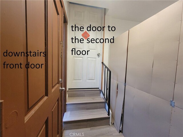 stairway featuring wood finished floors