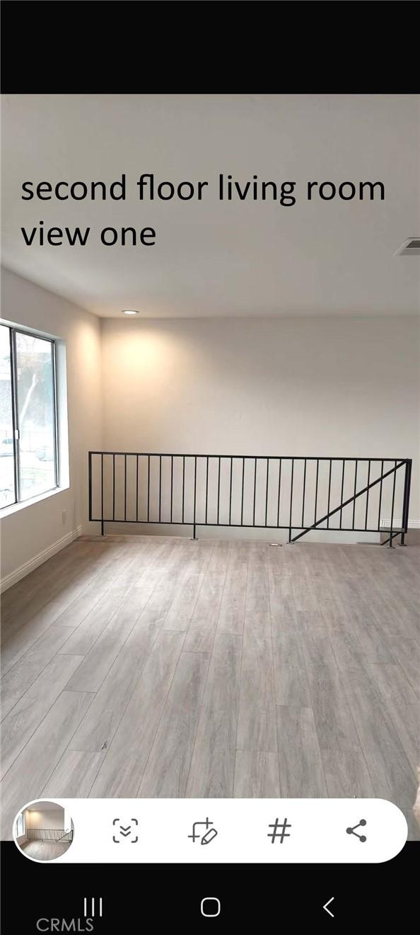 empty room with wood finished floors and baseboards