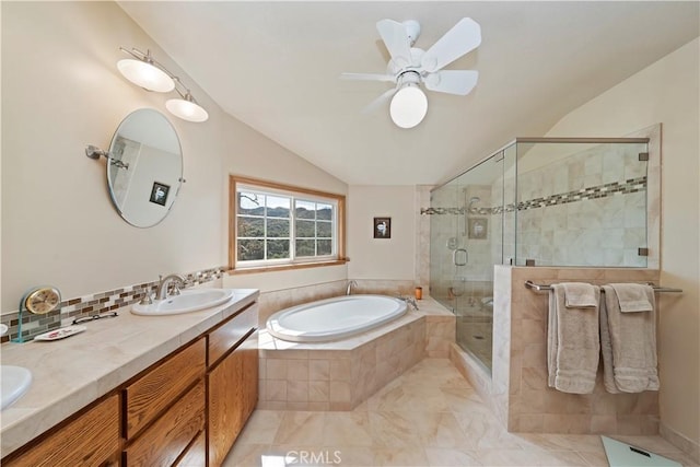 bathroom featuring double vanity, a stall shower, lofted ceiling, a bath, and a sink