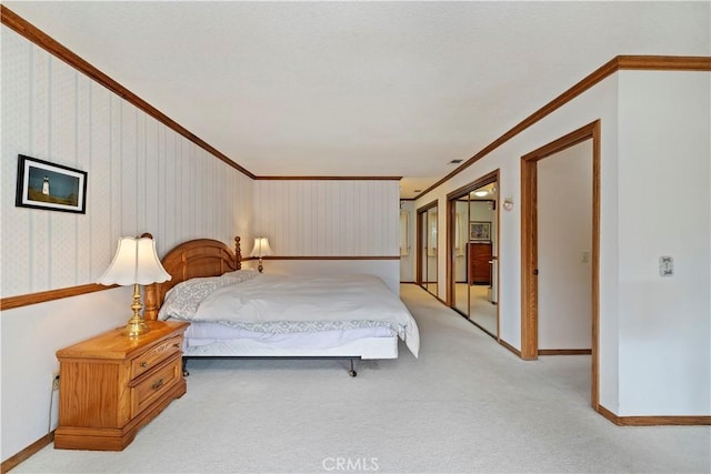 carpeted bedroom featuring crown molding, baseboards, and wallpapered walls