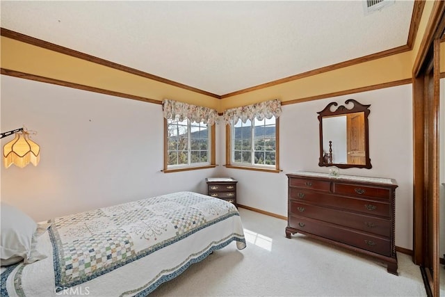 bedroom with ornamental molding, light carpet, visible vents, and baseboards