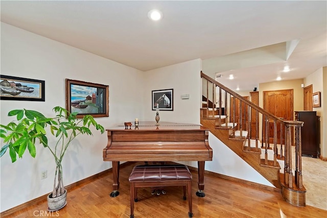 sitting room featuring light wood finished floors, stairs, baseboards, and recessed lighting