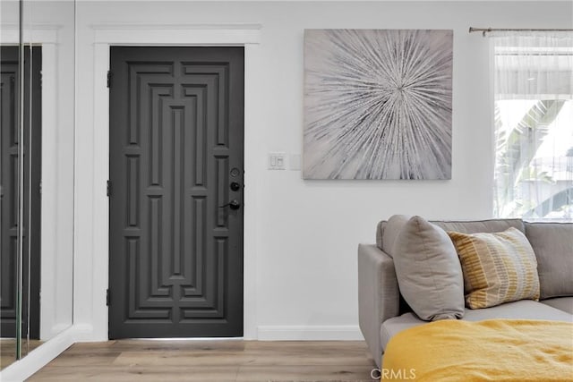 interior space with wood finished floors and baseboards