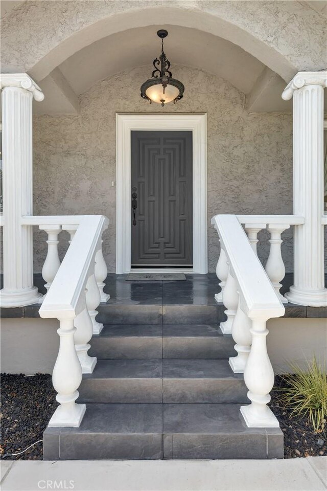 doorway to property with stucco siding