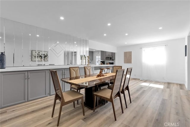 dining room featuring recessed lighting, light wood-style floors, and baseboards