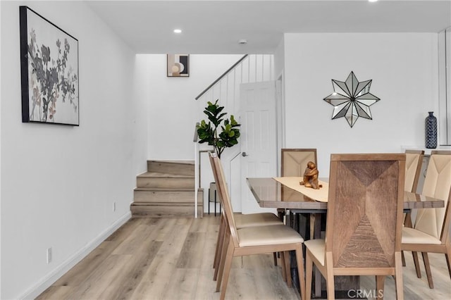 dining area featuring recessed lighting, stairway, light wood-style flooring, and baseboards