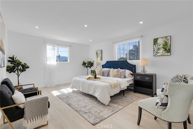 bedroom with multiple windows, recessed lighting, and light wood-style floors