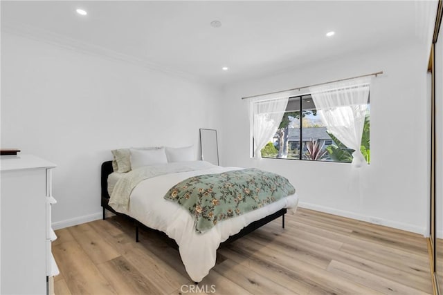 bedroom with recessed lighting, baseboards, and light wood-style flooring