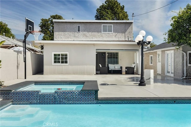 rear view of house featuring french doors, outdoor lounge area, a patio, an outdoor pool, and an in ground hot tub