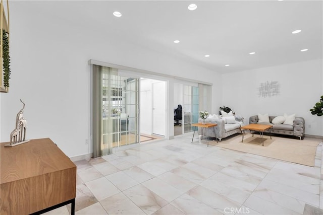 living area featuring plenty of natural light, recessed lighting, and baseboards