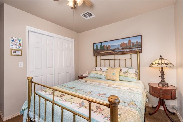 carpeted bedroom featuring ceiling fan, a closet, visible vents, and baseboards