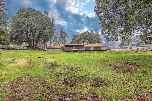 view of yard with fence and a deck