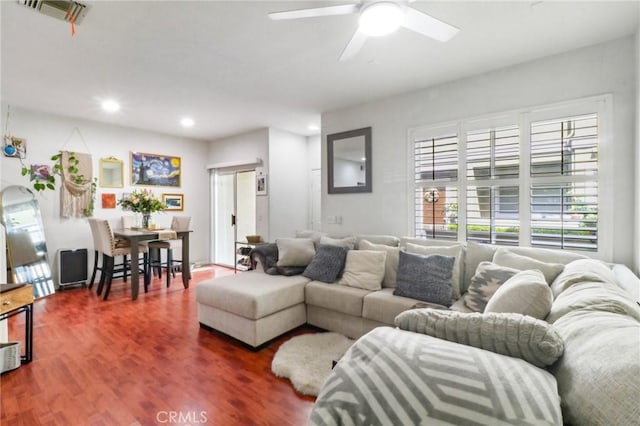 living area with a ceiling fan, recessed lighting, visible vents, and wood finished floors