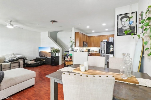 living area featuring dark wood-style flooring, recessed lighting, visible vents, and a ceiling fan