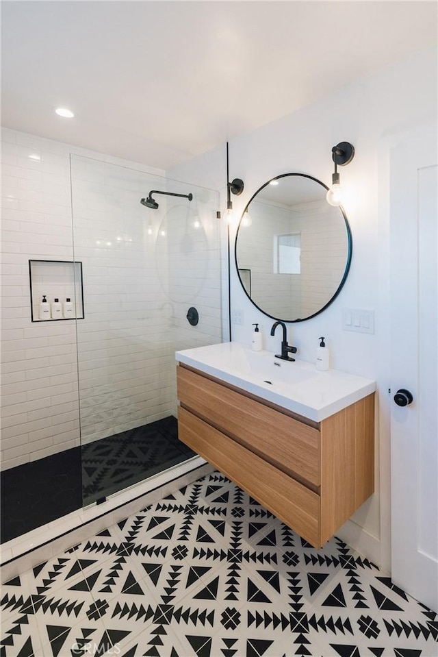 bathroom featuring tile patterned floors, vanity, and a walk in shower