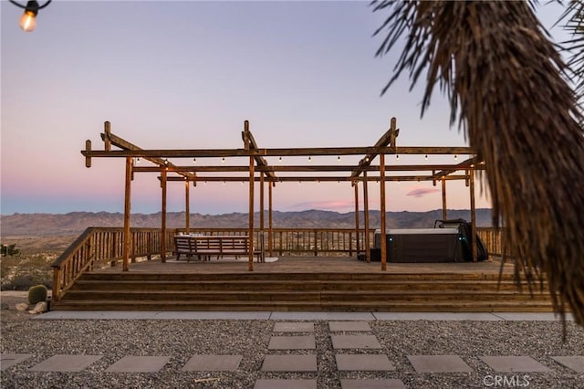 view of home's community with a deck with mountain view and a jacuzzi