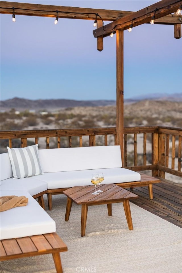 wooden terrace with an outdoor living space